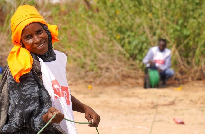 Two Sudanese refugees helping reel in ERT cable at the newly constructed Dougui Refugee Camp.